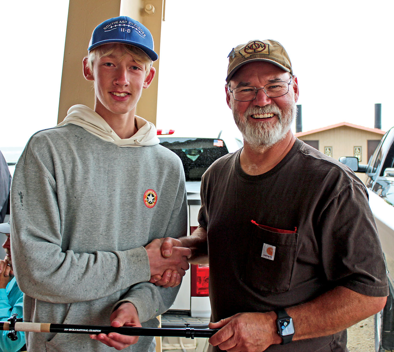 Cole Sauer is presented with his engraved scope by Jim Gier of Montana Vintage Arms.